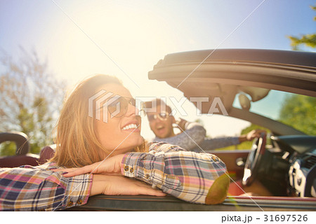 Couple of lovers driving on a convertible car - Couple of lovers driving on a convertible car - 31697526