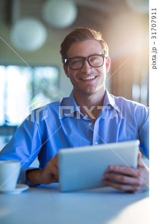 Portrait of smiling man using digital tablet Portrait of smiling man using digital tablet 31707911