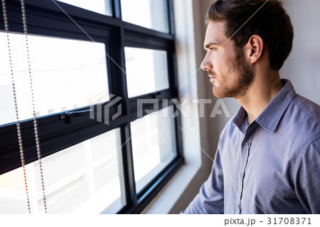 Businessman looking out of the window Businessman looking out of the window 31708371