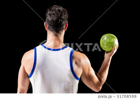 Rear view of male athlete holding ball 31708599
