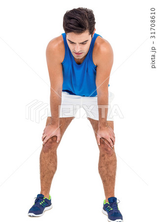 Tired athlete standing with hand on knee 31708610