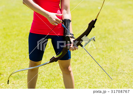 Mid-section of female athlete practicing archery Mid-section of female athlete practicing archery 31708767