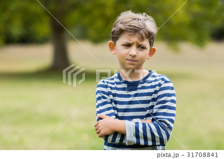 Portrait of upset boy standing with arms crossed Portrait of upset boy standing with arms crossed 31708841