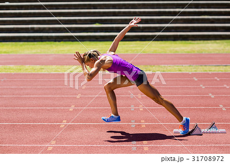Female athlete running on the racing track Female athlete running on the racing track 31708972