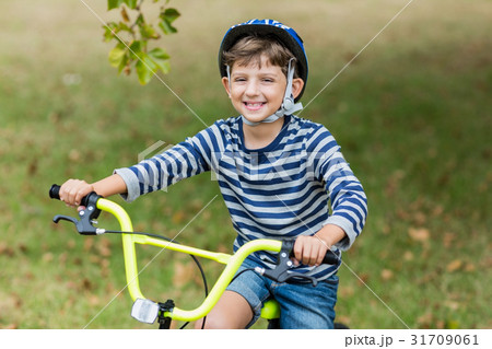Portrait of smiling boy riding a bicycle Portrait of smiling boy riding a bicycle 31709061