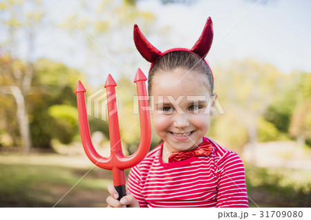 Adorable girl pretending to be a devil Adorable girl pretending to be a devil 31709080