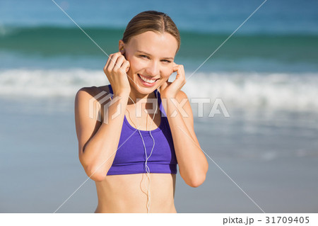 Portrait of beautiful woman listening music while exercising Portrait of beautiful woman listening music while exercising 31709405