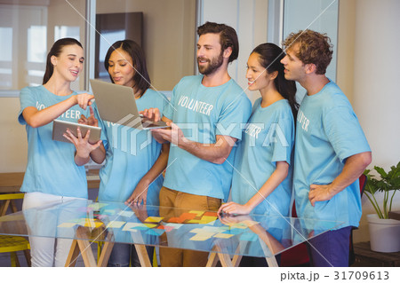 Volunteers using technology 31709613