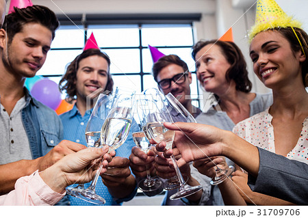 Happy coworker drinking champagne to celebrate a birthday 31709706