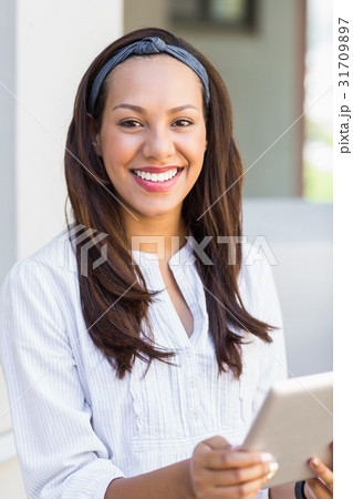 Smiling teacher using digital tablet in classroom Smiling teacher using digital tablet in classroom 31709897