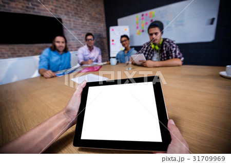 Photograph of a group of hipsters and a tablet computer Photograph of a group of hipsters and a tablet computer 31709969