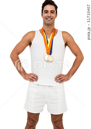 Athlete posing with gold medals around his neck Athlete posing with gold medals around his neck 31710407