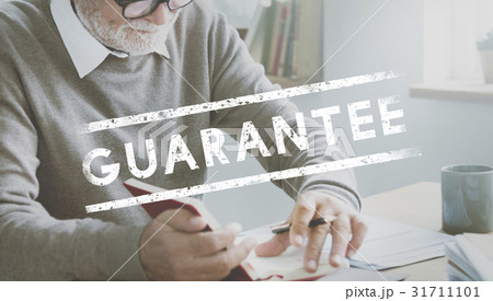 Senior man working on the table with guarantee word Senior man working on the table with guarantee word 31711101