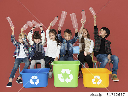 Kids and plastic bottles in a recycle bin 31712657