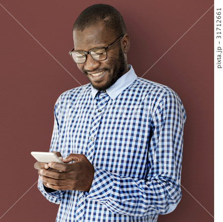 African Descent Guy is Smiling with Smartphone 31712661
