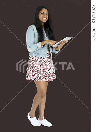 Young indian woman standing and using digital tablet Young indian woman standing and using digital tablet 31713078