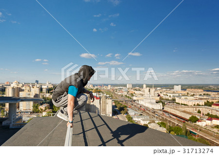 Roofer sits on the railing 31713274