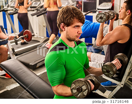 Friends in gym fitness workout equipment. Man do 31716146
