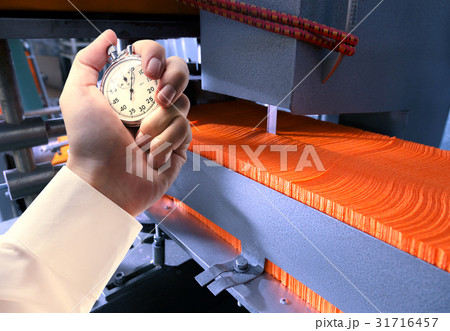 Process of paper manufacturing, stopwatch in hand 31716457