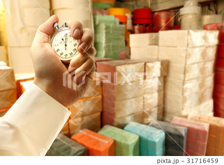 Paper products storehouse and stopwatch in hand Paper products storehouse and stopwatch in hand 31716459