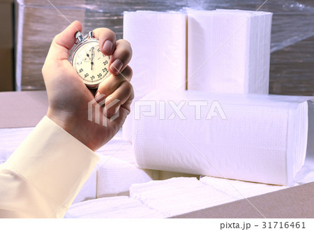 Paper napkins, towels and stopwatch in male hand Paper napkins, towels and stopwatch in male hand 31716461