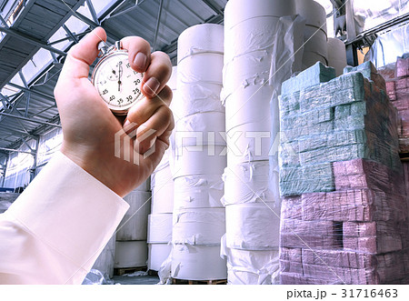 Paper products storehouse and stopwatch in hand 31716463