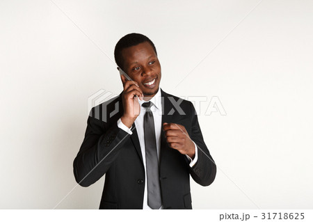 Cheerful businessman talking on mobile phone 31718625