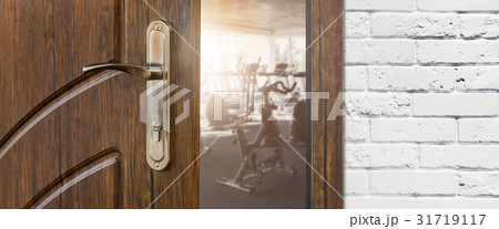 Entrance to gym in fitness club, opened door with 31719117