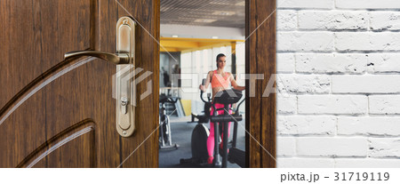 Entrance to gym in fitness club, opened door with 31719119