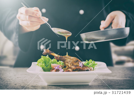 The chef prepares a gourmet meal. 31721439