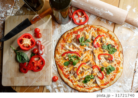 Baked pizza with chicken and paprika and Baked pizza with chicken and paprika and 31721740