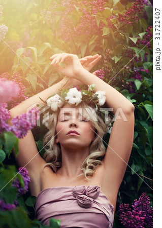 Beautiful Woman Relaxing in Flowers Outdoors Beautiful Woman Relaxing in Flowers Outdoors 31722407