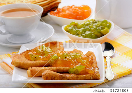 Pancakes with jam and cup of tea. 31722803