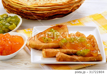 Pancakes with jam and cup of tea. 31722804