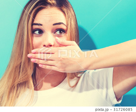 Young woman covering her mouth 31726085