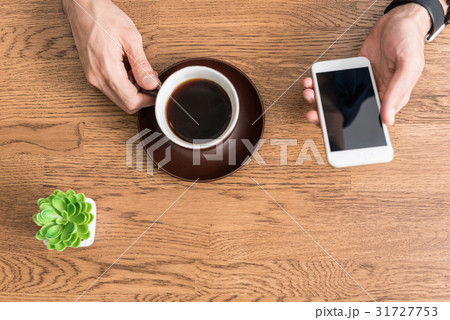 Youthful guy having break with hot beverage at 31727753