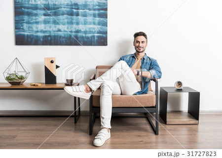 Cheery youthful guy spending free time at home 31727823
