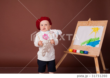 little boy artist brush and paints paints a little boy artist brush and paints paints a 31731260