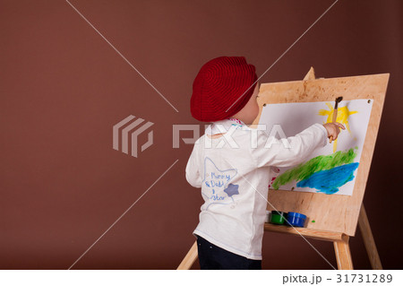 little boy artist brush and paints paints a 31731289