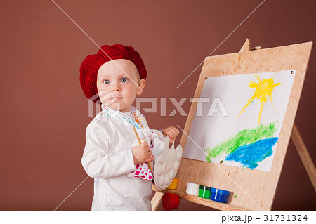 little boy artist brush and paints paints a 31731324