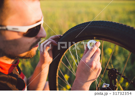 A young guy on a mountain bike uses a cycling computer A young guy on a mountain bike uses a cycling computer 31732354