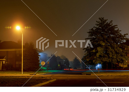 Car trace on an empty night road in a fog Car trace on an empty night road in a fog 31734929