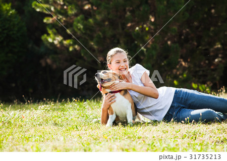 Girl plays with a dog Girl plays with a dog 31735213