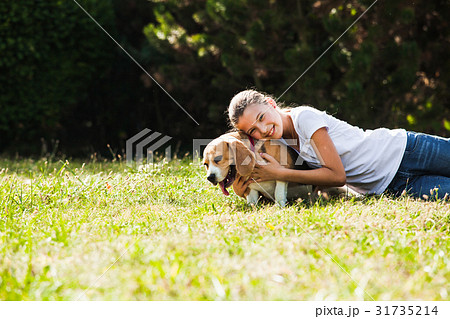 Girl plays with a dog Girl plays with a dog 31735214