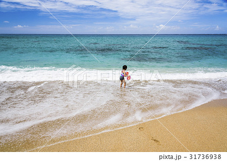 Little girl playing on beach. 31736938