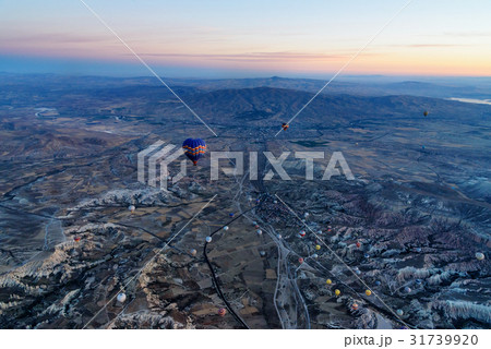 Hot air balloons flying over valley at sunrise 31739920