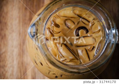 Top view of iced coffee on wooden table Top view of iced coffee on wooden table 31744170