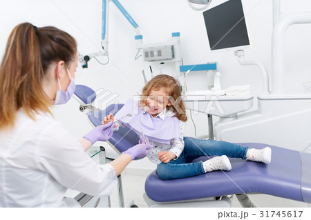 Little girl in dentist chair 31745617