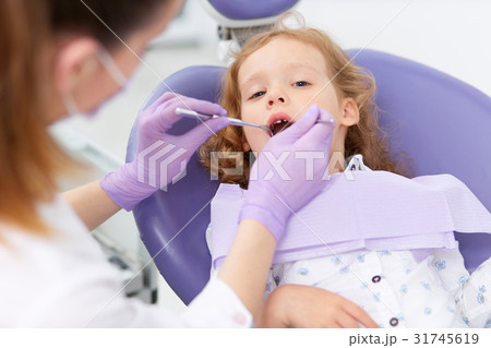 Pediatric dentist with patient 31745619