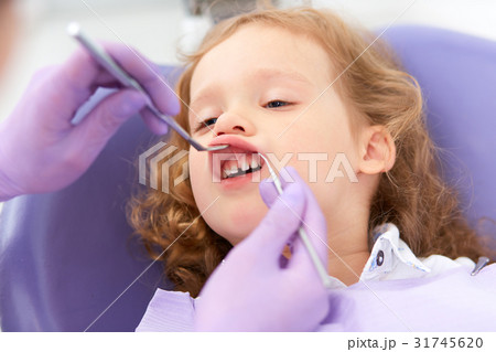 Dentist examining under lip 31745620